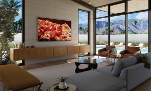 The Sony Bravia XR X93L 4K Google TV hanging over a media center in a living room.
