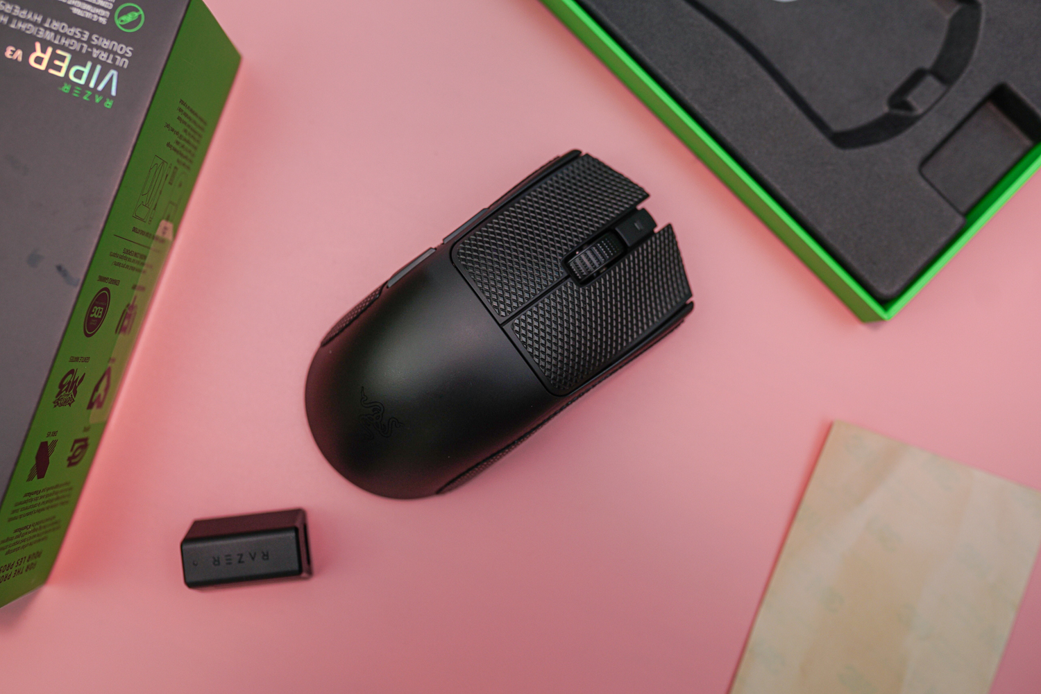 The Razer Viper V3 Pro sitting among its accessories.