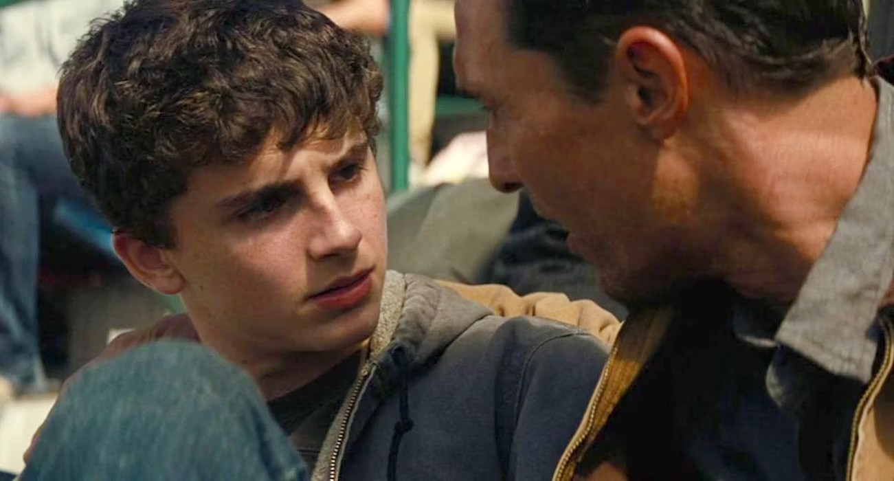 A boy looks at his father in Interstellar.