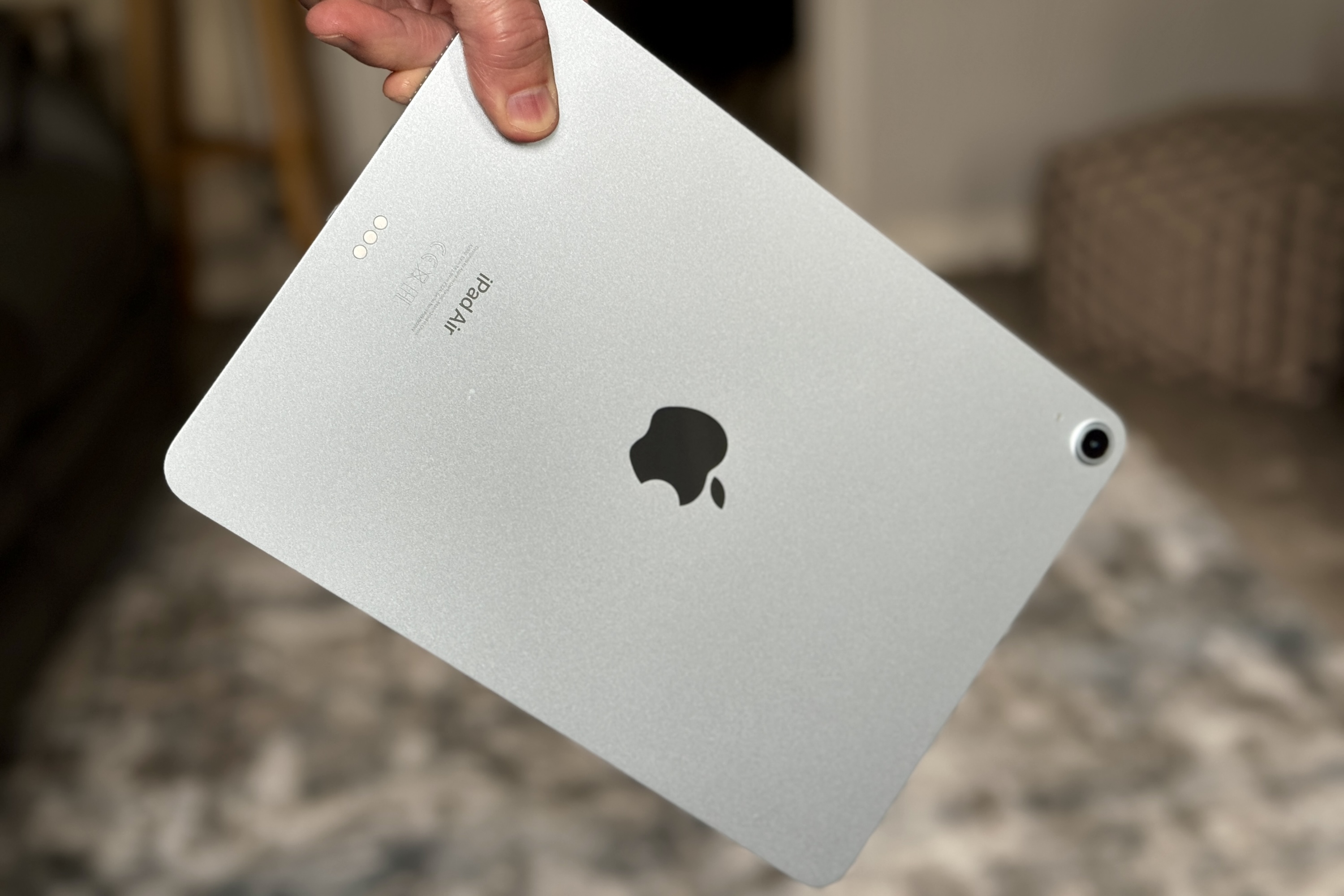 A person holding the iPad Air M2.