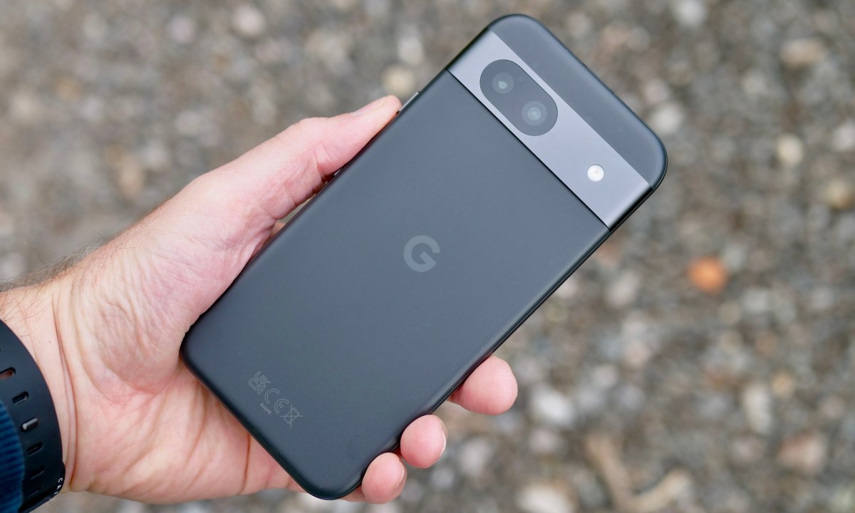 A person holding the Google Pixel 8a, showing the back.