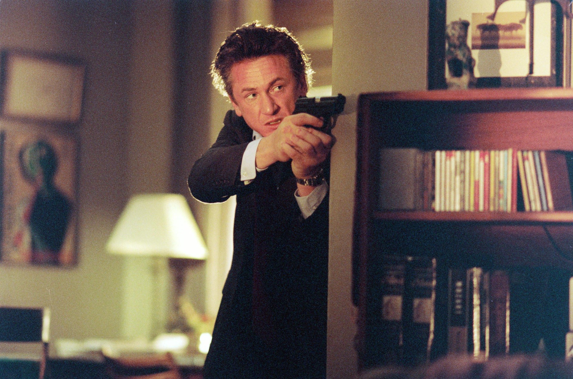 A man points his gun in The Interpreter.