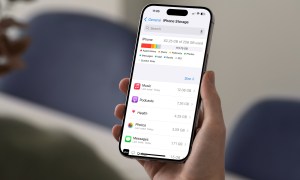 Person holding an iPhone showing current storage.