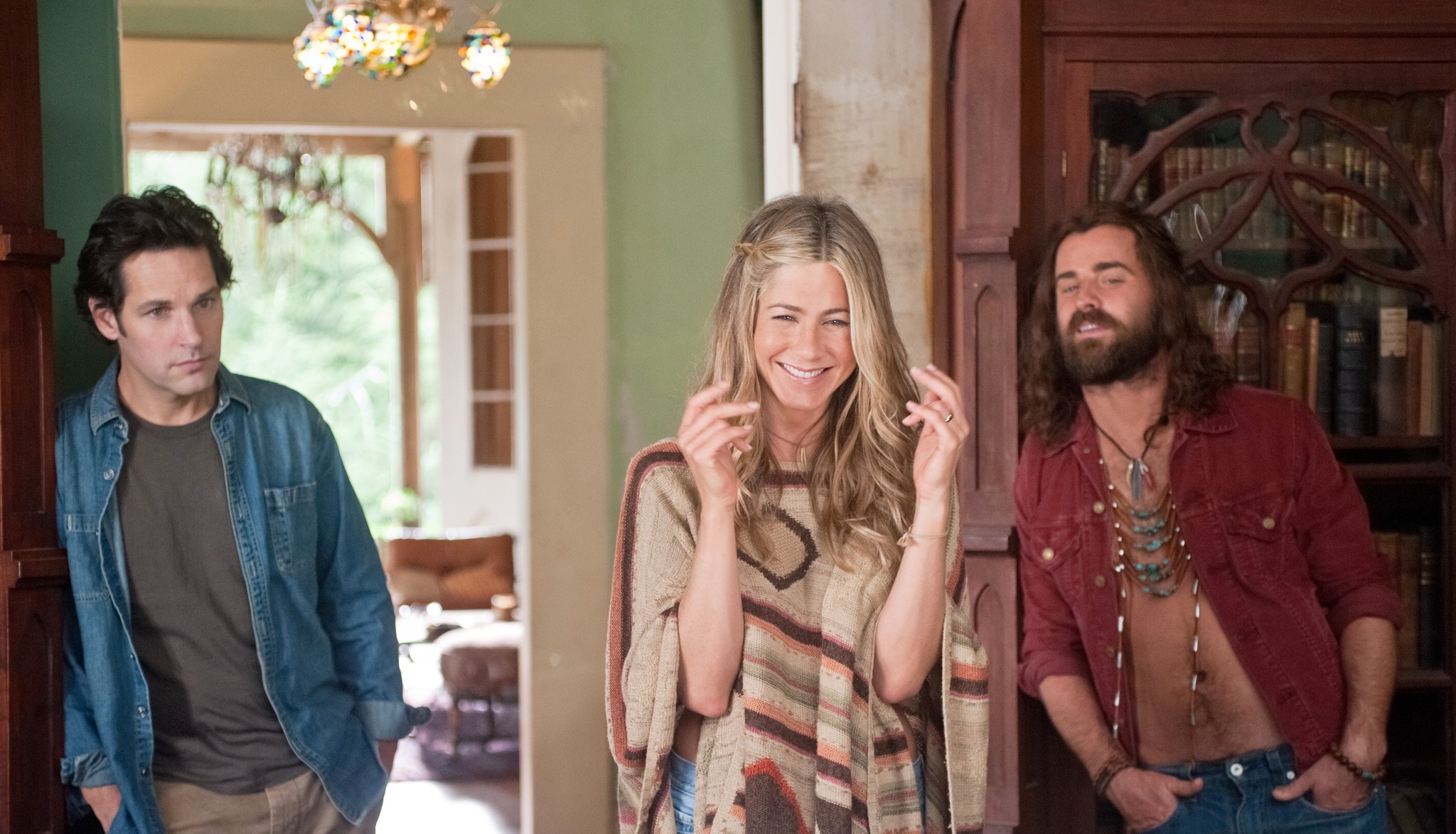 Three people stand and laugh in Wanderlust.