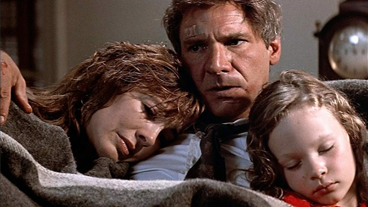 A man sits with his wife and daughter in Patriot Games.