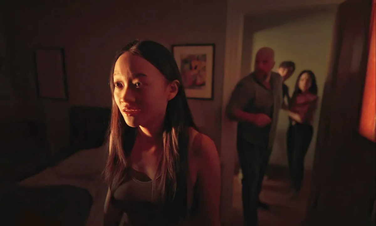 A girl looks scared as her family stands off in the background.