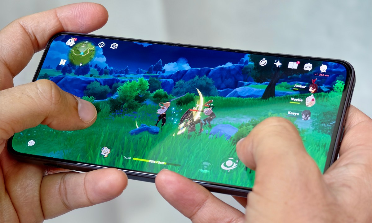 Someone playing Genshin Impact on a phone