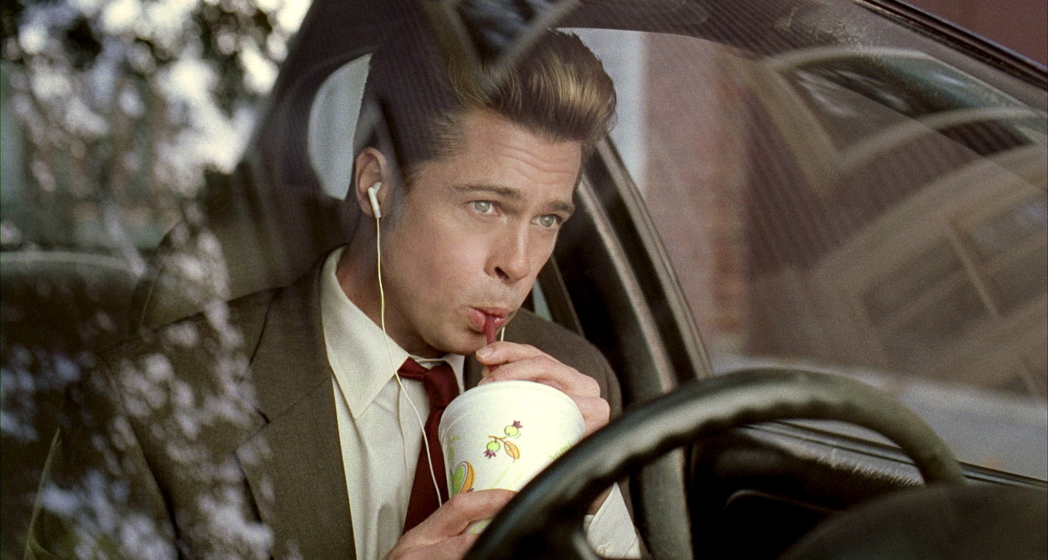 A man sips from a cup in Burn After Reading.