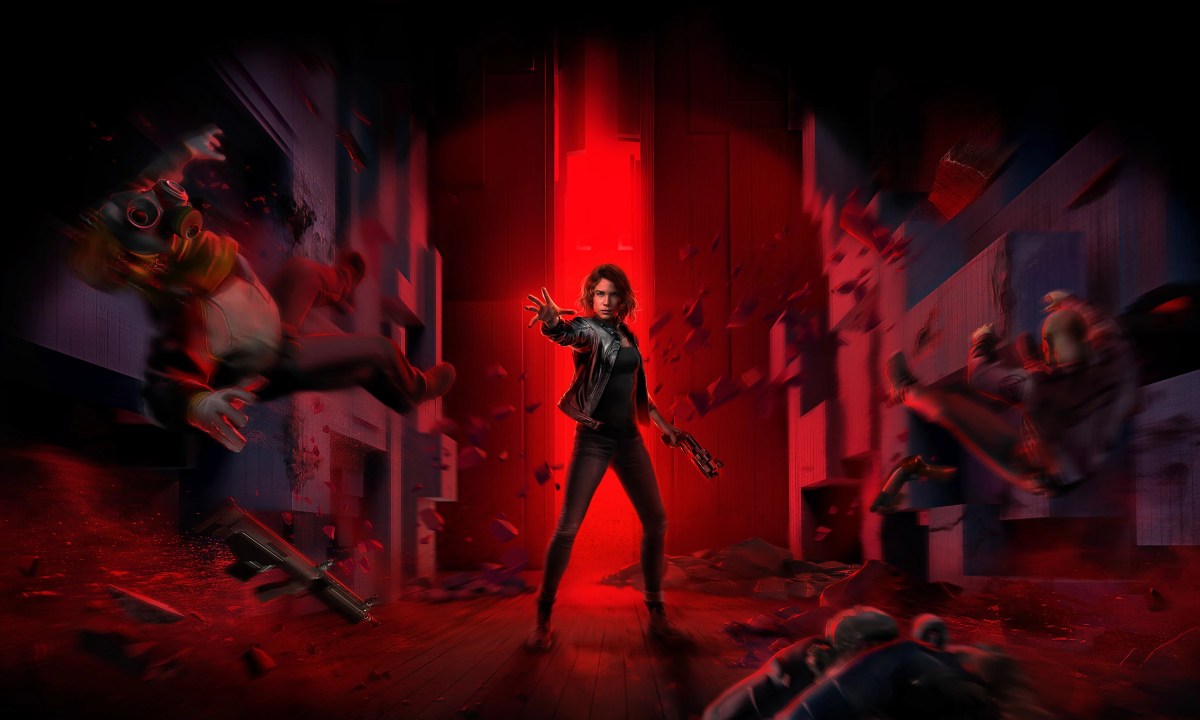 Jesse from Control stands in front of a red backdrop.