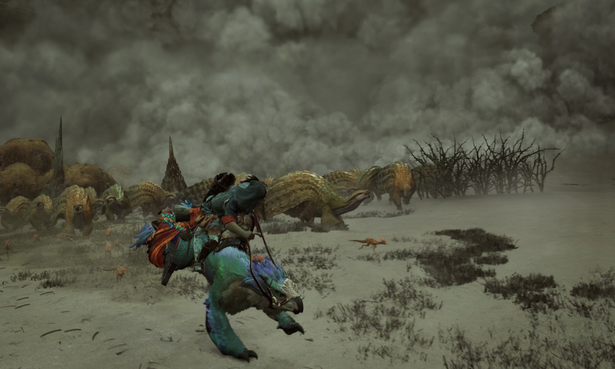 A hunter runs from a dust storm in Monster Hunter Wilds.