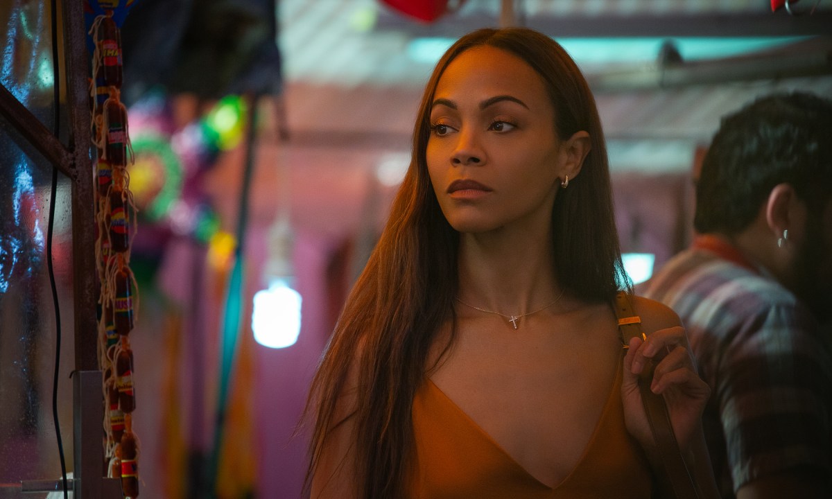 Zoe Saldaña looks to her right and stops in a still from the movie Emilia Pérez