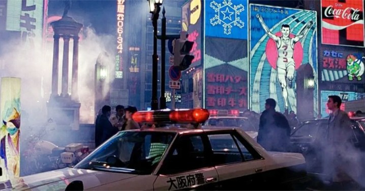 A man walks in a crowded street in Black Rain.