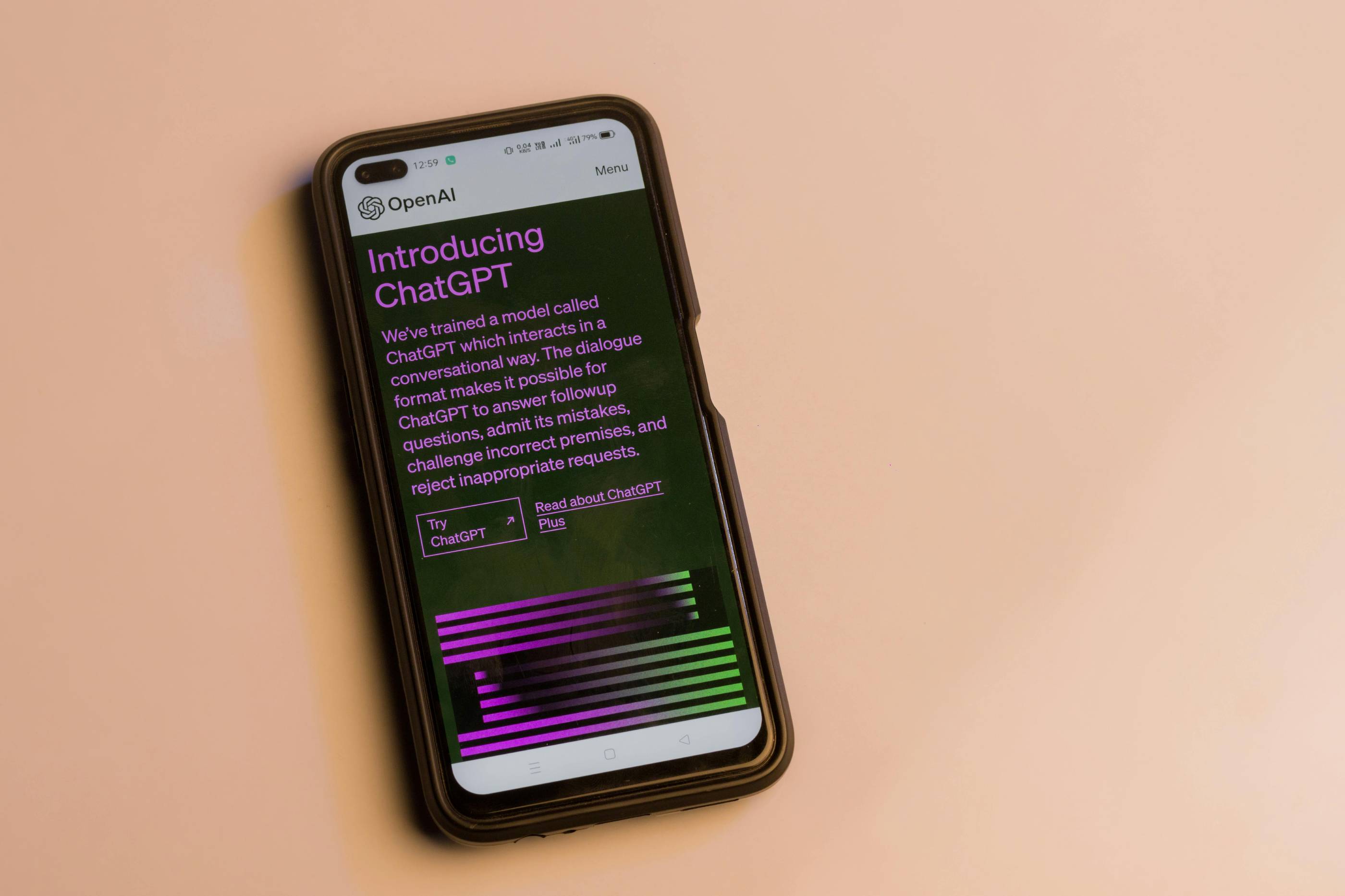 a phone displaying the ChatGPT homepage on a beige background.