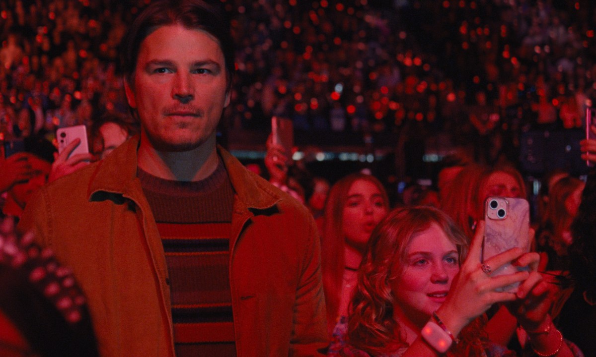 Josh Hartnett stands covered in red light in Trap.