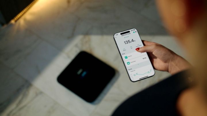 The Wyze mobile app next to the Wyze Scale Ultra.