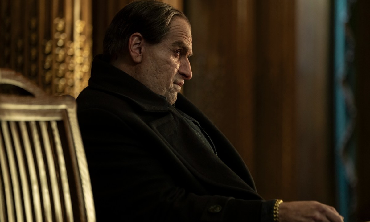 Colin Farrell sits in a chair in The Penguin.