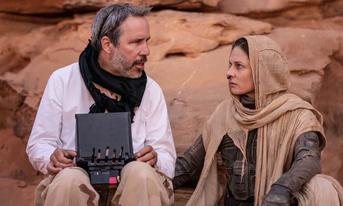 Denis Villeneuve sitting with Rebecca Ferguson on the set of "Dune: Part Two."