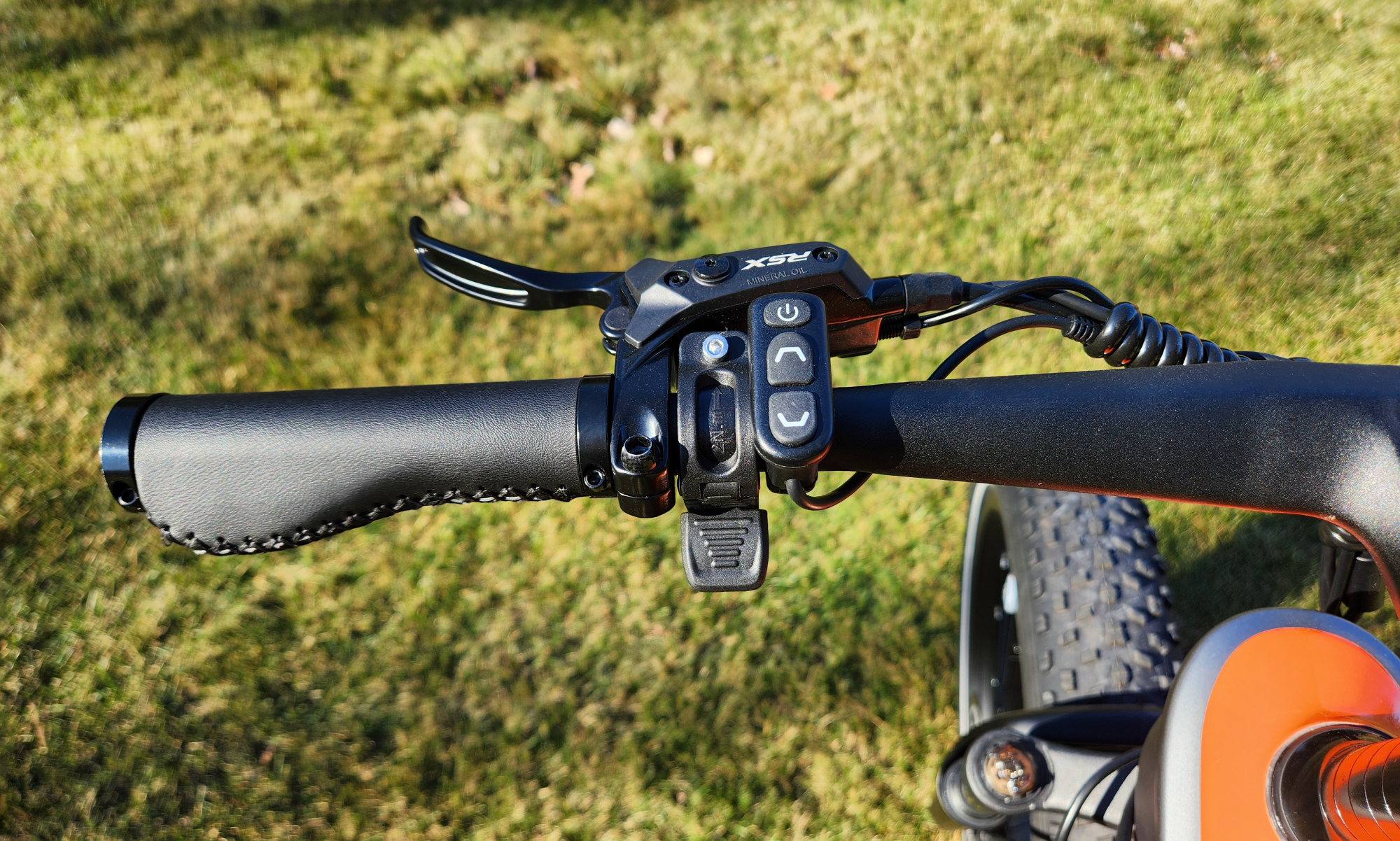 HeyBike Hero e-bike handlebar left side with front brake lever, control pad, and thumb throttle.