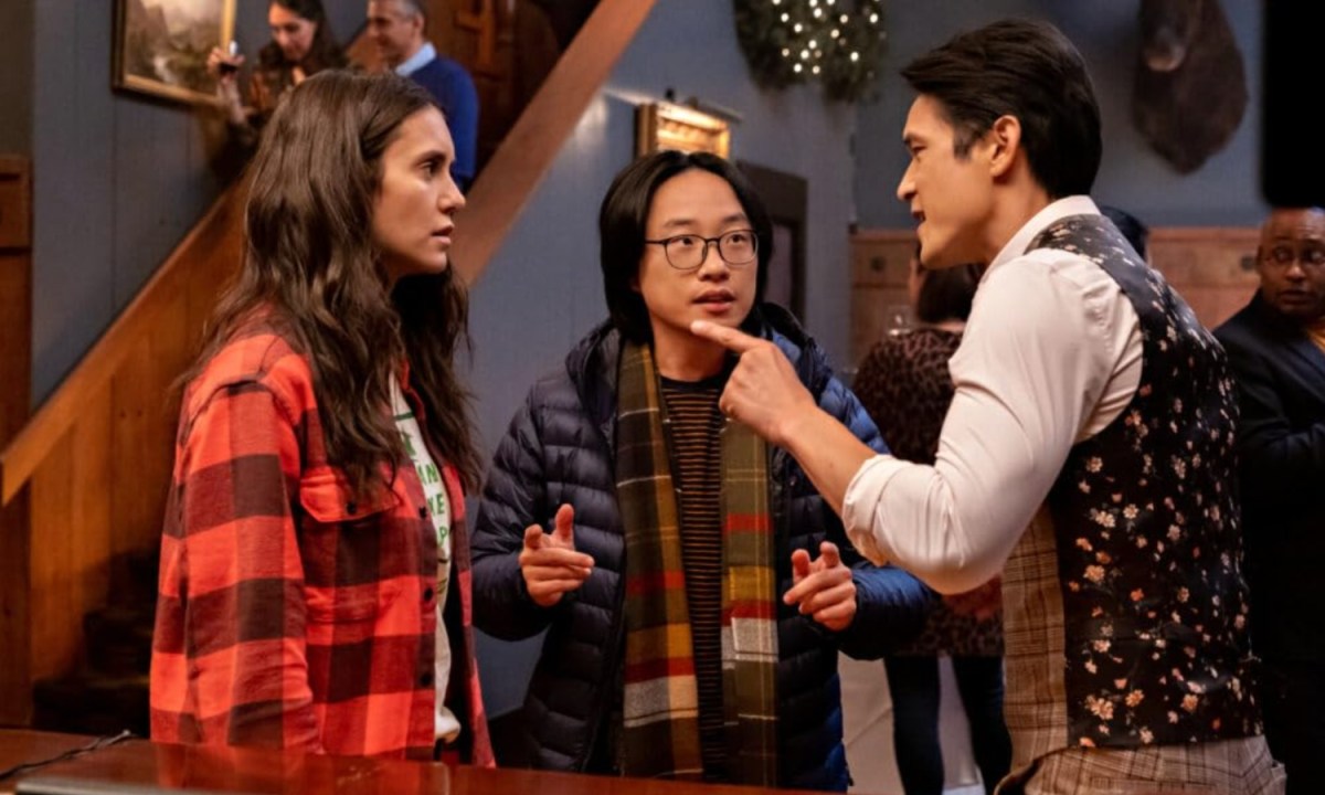 A man berates a woman as another man stands in the middle.