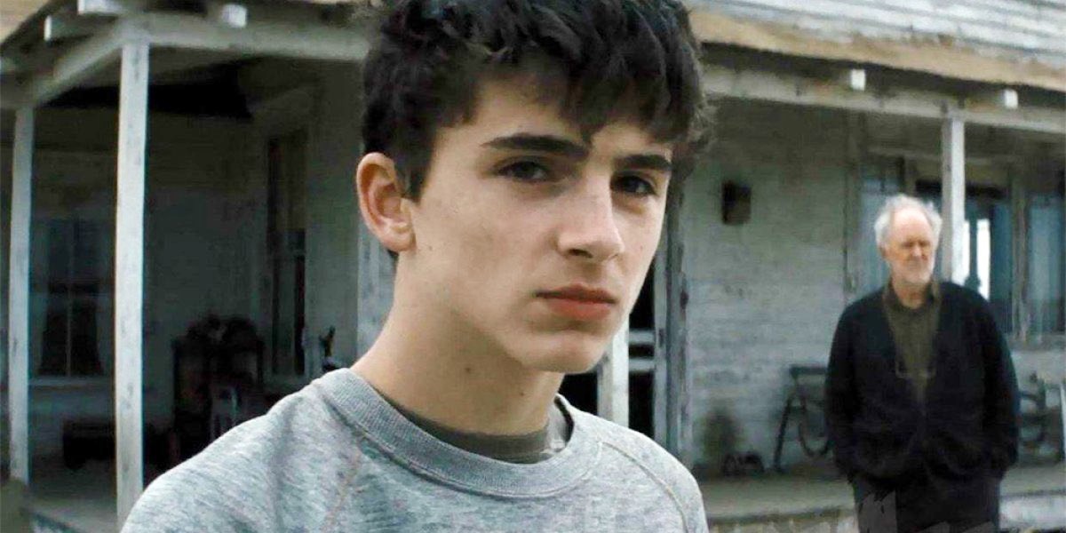 A teen boy looks in the distance in Interstellar.