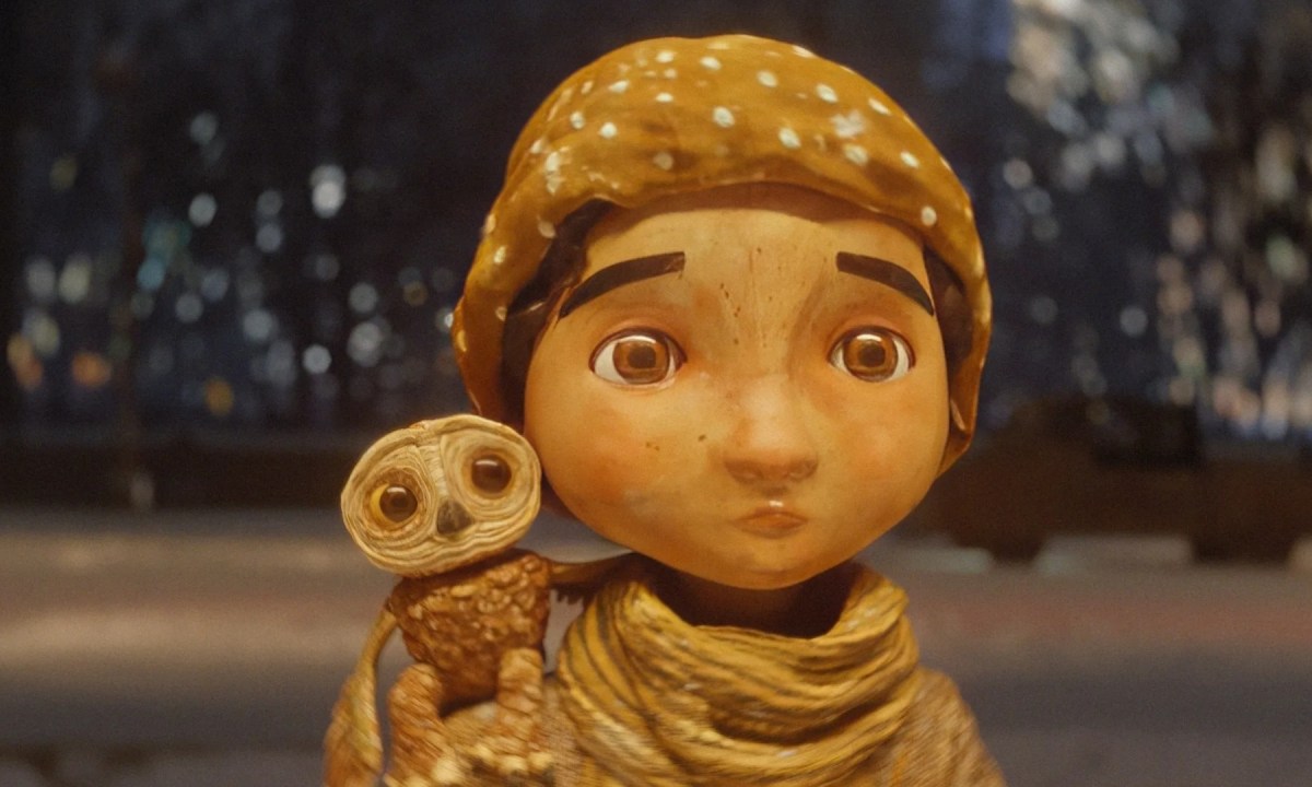 The owl Moon perched on Luna's shoulder in An Almost Christmas Story.
