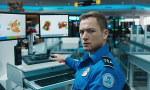 A TSA agent looks concerned in Carry-On.