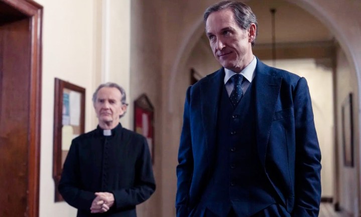 A man stands in front of a priest in Dalgliesh.