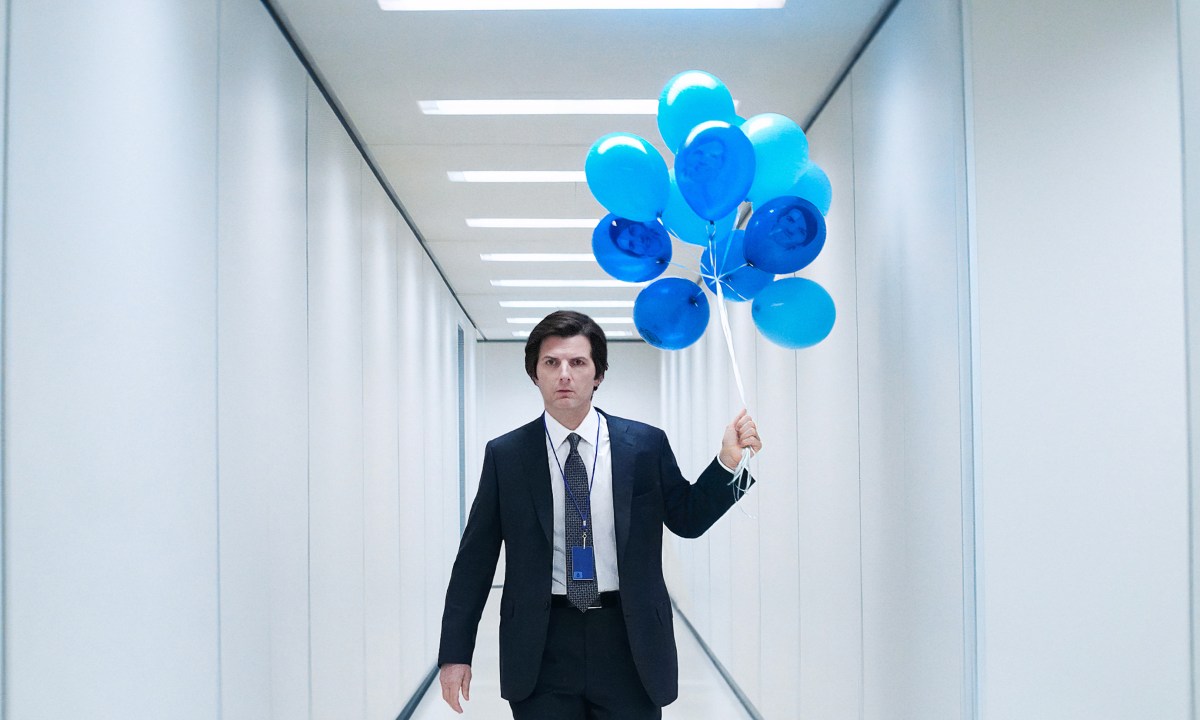 Adam Scott holds blue balloons in Severance season 2.