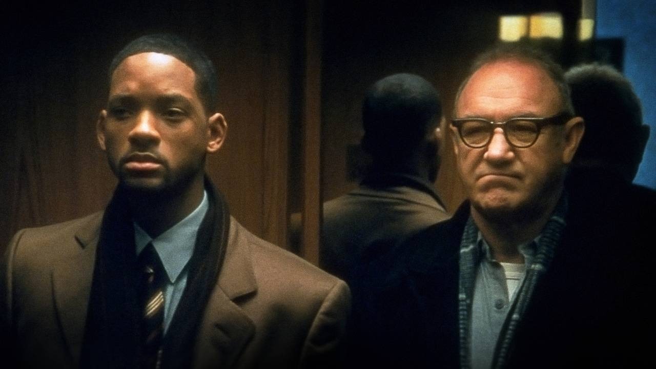 Will Smith and Gene Hackman side by side in an elevator, both looking angry in Enemy of the State.