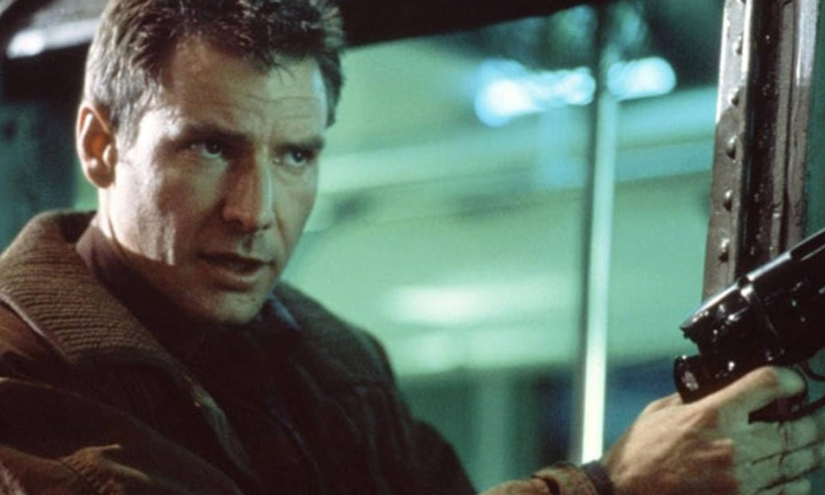 Harrison Ford points a gun and stares.