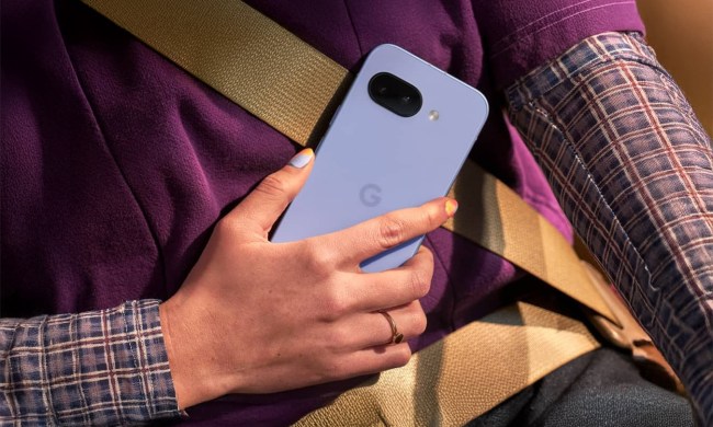 Person holds Pixel 9a in hand while sitting in a car.