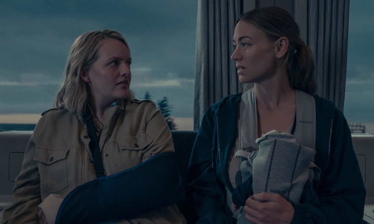 June and Serena on a train together looking at one another, Serena holding baby Nichole in The Handmaid's Tale.