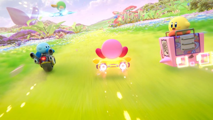 Three Kirbys racing on a green field.