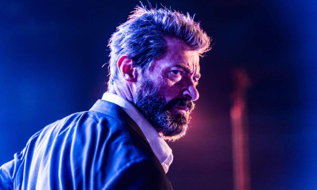 Hugh Jackman as Wolverine looking over his shoulder in Logan.
