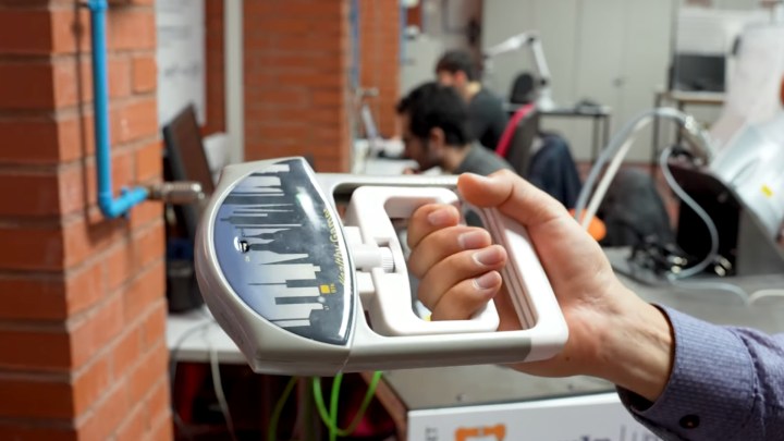 Person holding an eJamar wireless controller in their hand.